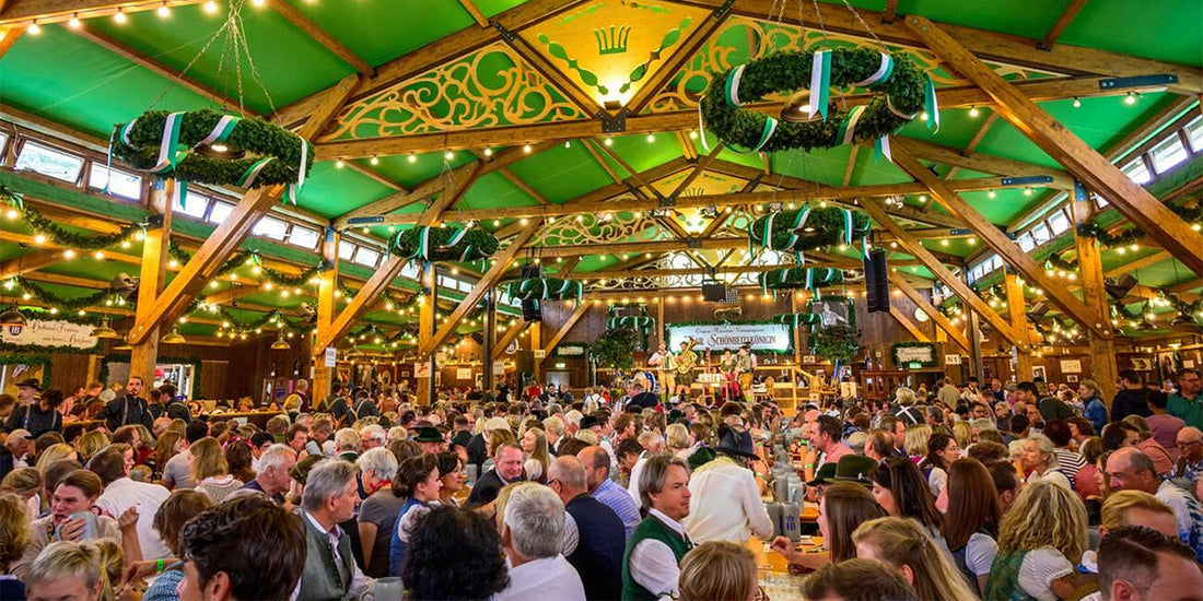 Crowded Oktoberfest beer tent with people drinking and socializing, showing common festival mistakes to avoid