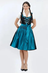 Elegant black Bavarian dirndl with a vibrant teal apron, decorative ribbon-laced bodice, and white blouse inspired by timeless German traditional fashion