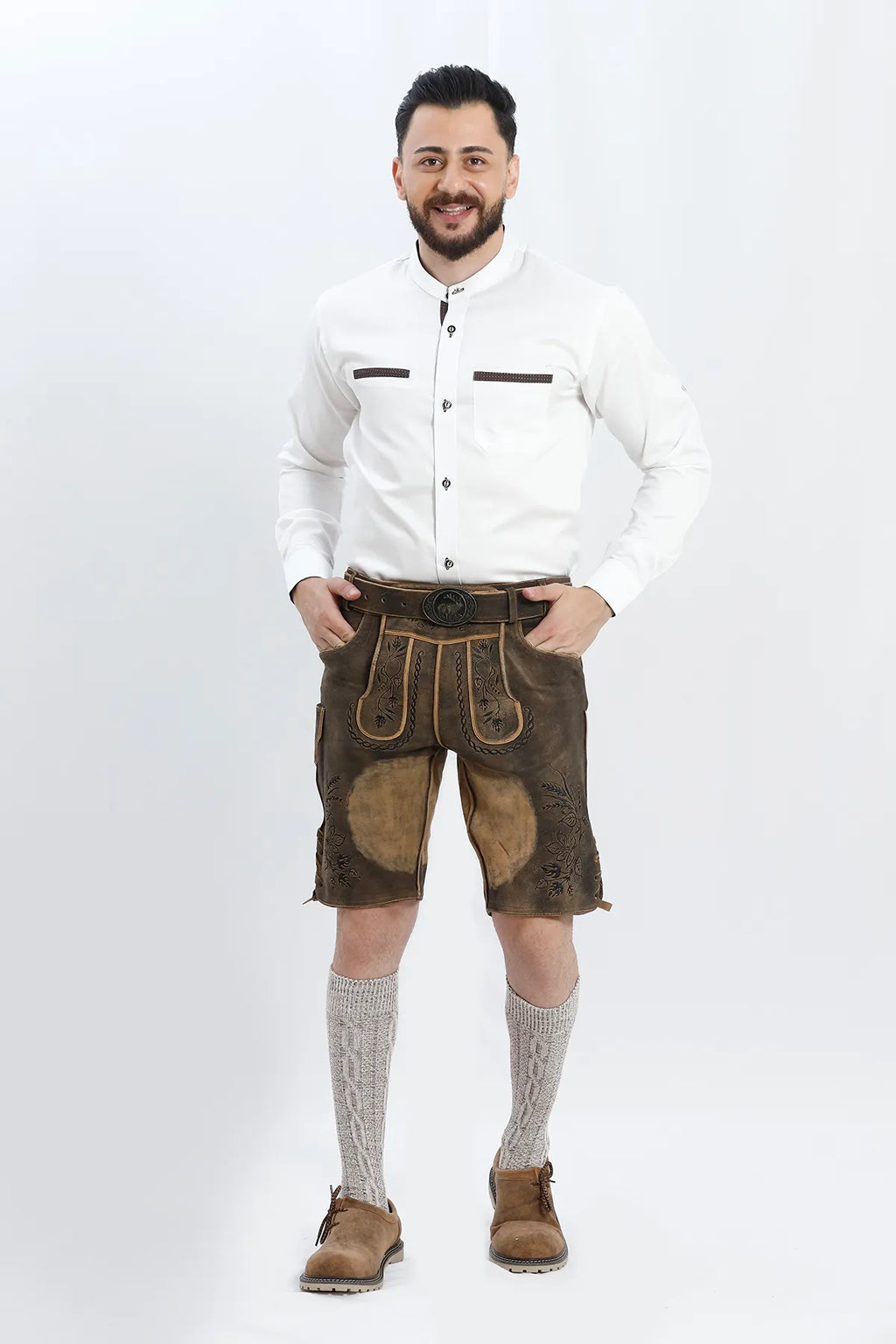 Lederhosen Men in Brown Color with Traditional Embroidery. Model is wearing White Traditional Shirt with Bavarian Socks and Shoes.