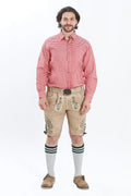 Lederhosen Men in Beige Brown Color with Traditional Green Embroidery. Model is wearing Checkered shirt and Traditional Bavarian Shoes.