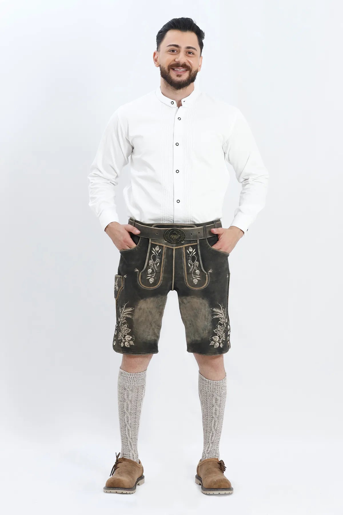 Lederhosen Men in Vintage Black with Traditional Bavarian Embroidery. Model is wearing Traditional White Shirt, Bavarian Socks and Smoke Brown Lederhosen Shoes.