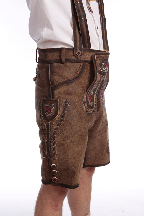 Brown suede lederhosen with rose embroidery and lion motif, gold-trimmed bib with decorative pockets