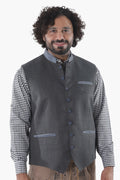 Steel grey wool vest with button front, breast pockets, and subtle grey piping for Alpine traditionSteel grey wool vest with button front, breast pockets, and subtle grey piping for Alpine tradition