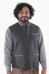 Steel grey wool vest with button front, breast pockets, and subtle grey piping for Alpine traditionSteel grey wool vest with button front, breast pockets, and subtle grey piping for Alpine tradition