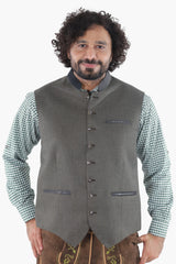 Forest green wool vest with dark leather trim, button front, and chest pockets for traditional Bavarian wear