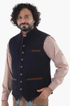 Navy tweed Bavarian vest with brown leather trim and decorative metal buttons, traditional folk styling